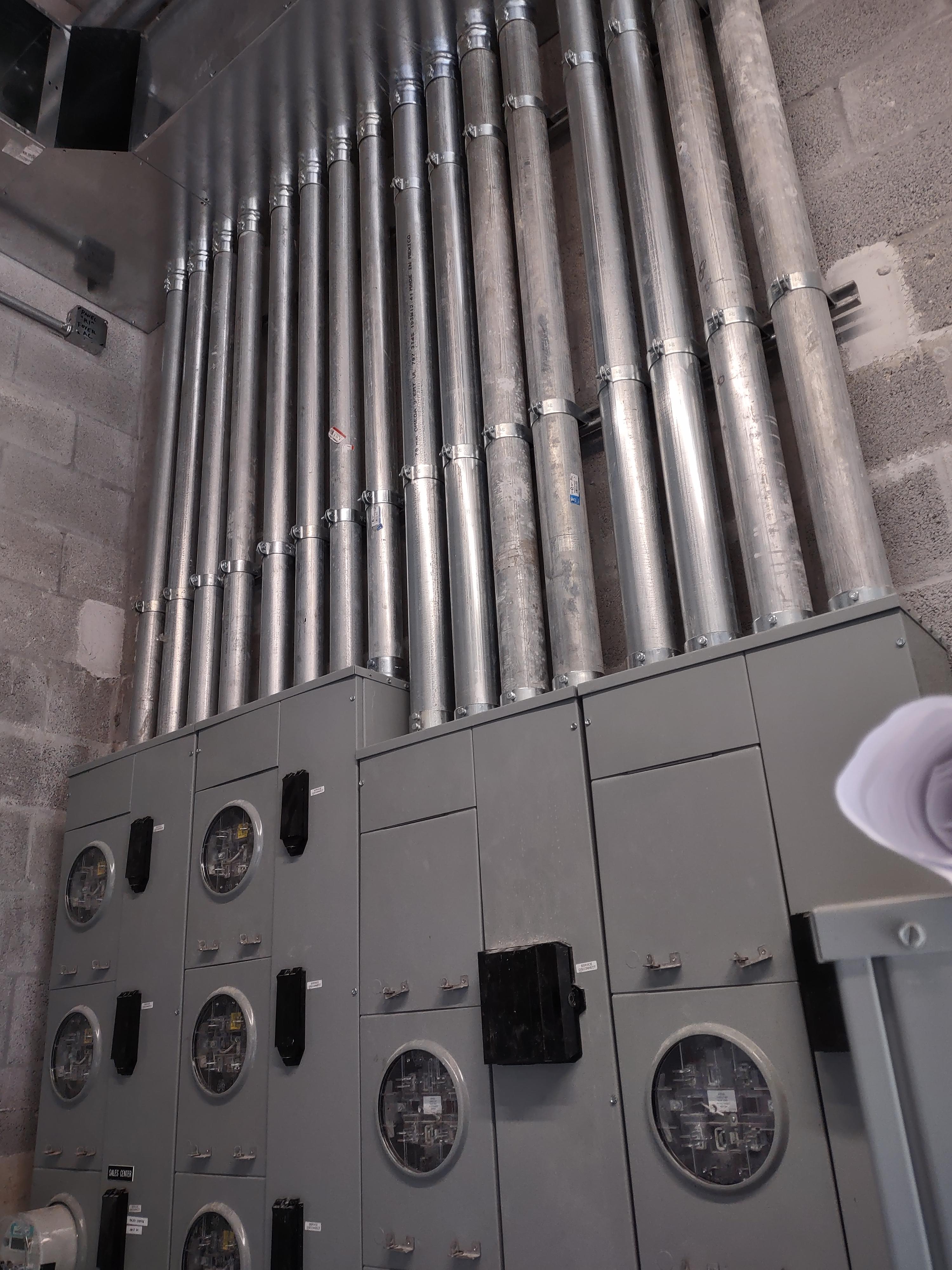 Electrical meter cabinets and metal conduits
