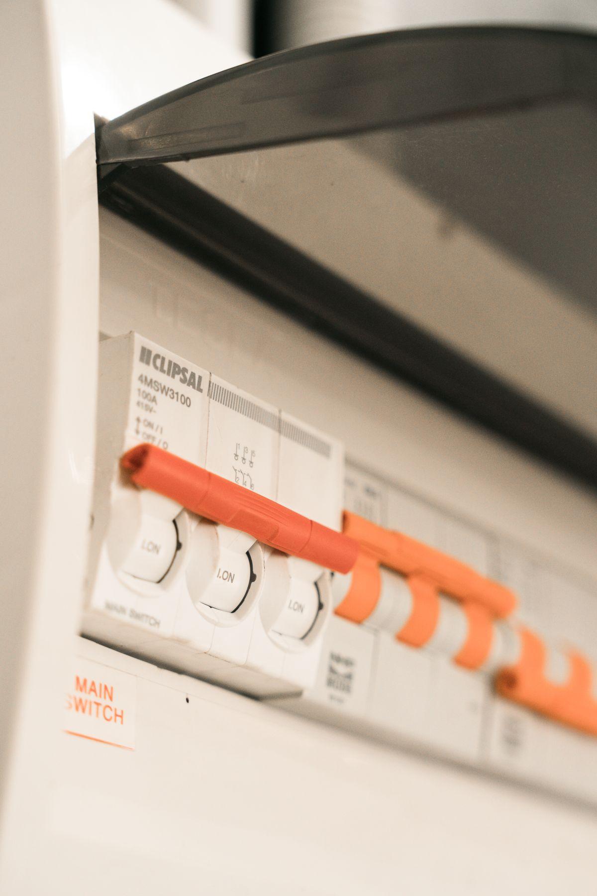 Close-up of electrical circuit breakers and panel hardware